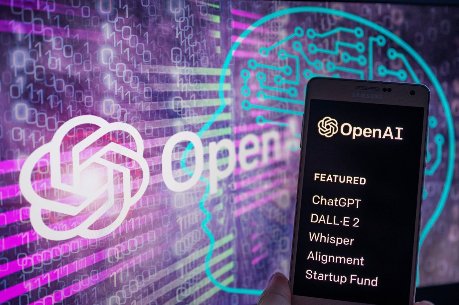 OpenAI – ChatGPT Illustration OpenAI logo seen on screen with ChatGPT website displayed on mobile seen in this illustrat