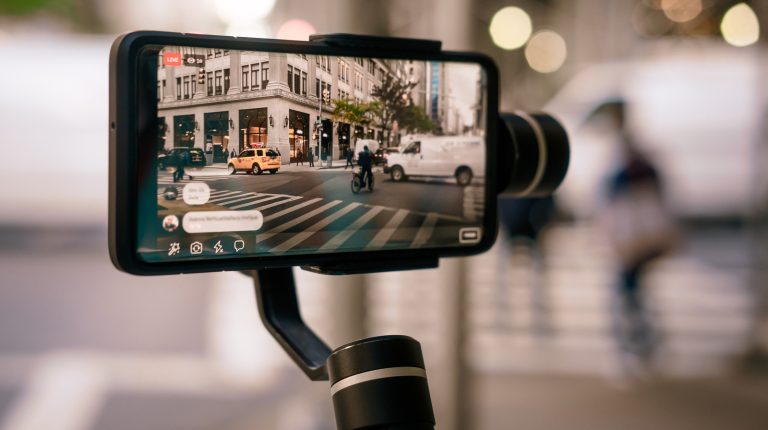 Man,Using,Phone,With,Stabilizer,And,Taking,Pictures,And,Live
