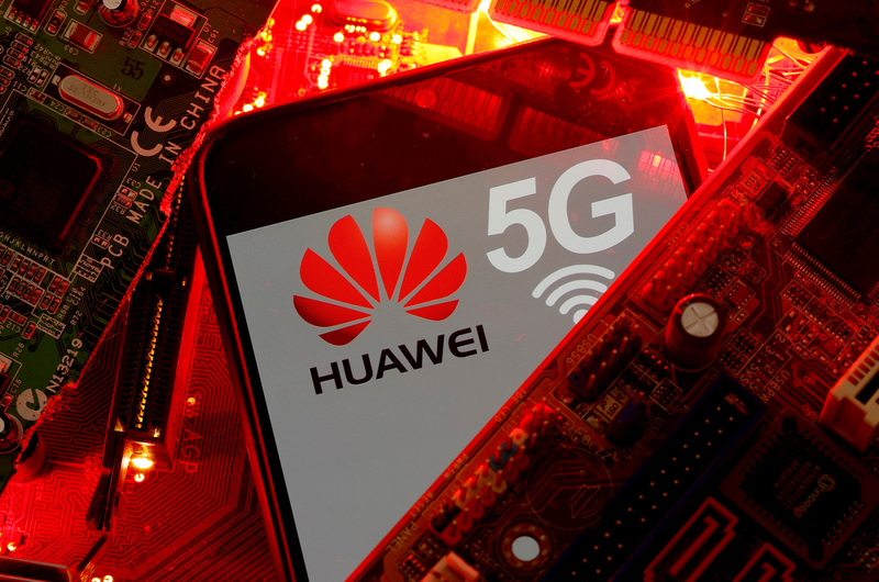 FILE PHOTO: A smartphone with the Huawei and 5G network logo is seen on a PC motherboard in this illustration